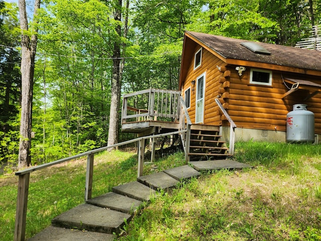 75 Snow Goose Ln, Dexter, ME 04930 - view of home's exterior featuring stairs, log exterior, and a wooden deck