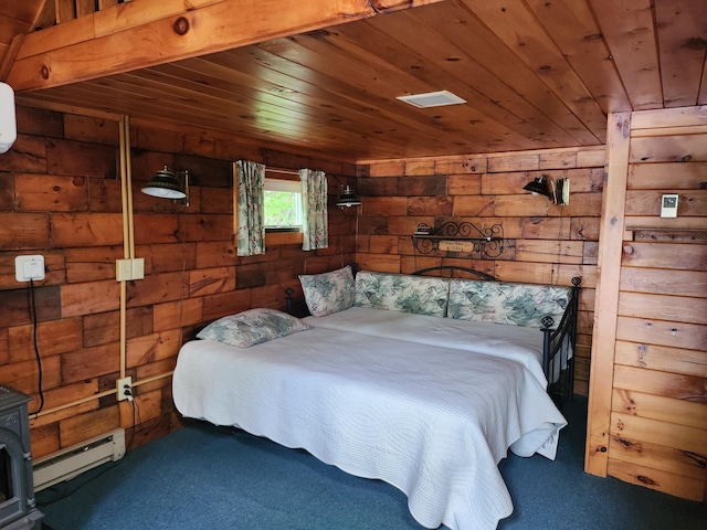 75 Snow Goose Ln, Dexter, ME 04930 - bedroom featuring baseboard heating, carpet floors, wooden walls, wooden ceiling, and a wood stove