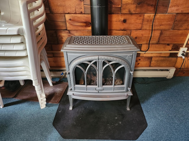 75 Snow Goose Ln, Dexter, ME 04930 - detailed view of a wood stove, carpet floors, and a baseboard radiator