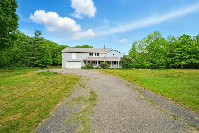 473 Davenport Hill Rd, Jay, ME 04239 - view of front of home with a front lawn, an attached garage, driveway, covered porch, and a chimney