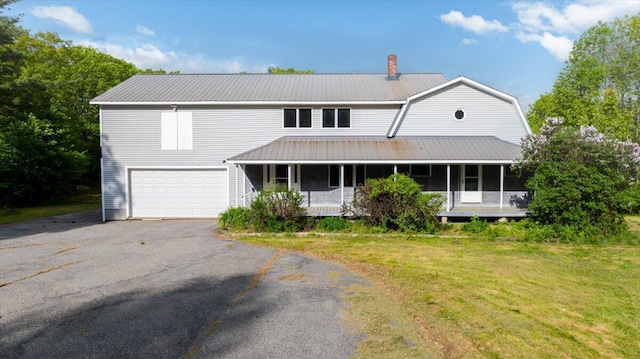 473 Davenport Hill Rd, Jay, ME 04239 - view of front of house with metal roof, covered porch, a garage, a front yard, and a chimney