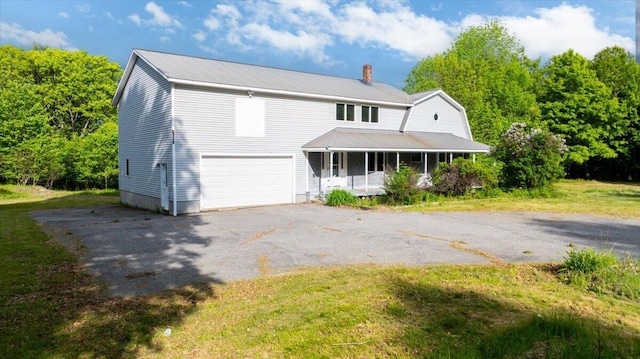 473 Davenport Hill Rd, Jay, ME 04239 - view of front of house with an attached garage, a chimney, covered porch, driveway, and metal roof