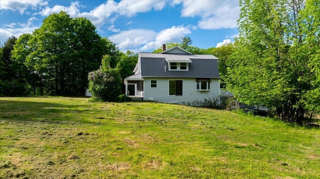 473 Davenport Hill Rd, Jay, ME 04239 - back of house with metal roof, a chimney, and a lawn