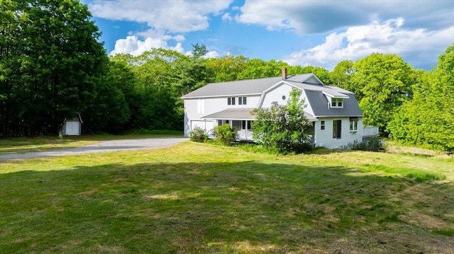 473 Davenport Hill Rd, Jay, ME 04239 - dutch colonial with a front lawn, asphalt driveway, a gambrel roof, a chimney, and metal roof