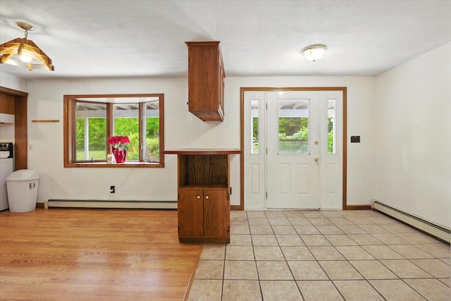 473 Davenport Hill Rd, Jay, ME 04239 - foyer with a baseboard heating unit, light wood-style flooring, and baseboards