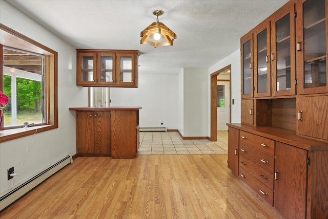 473 Davenport Hill Rd, Jay, ME 04239 - dining area featuring baseboard heating, a baseboard heating unit, light wood-style flooring, and baseboards