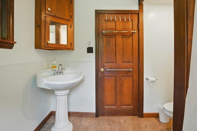 473 Davenport Hill Rd, Jay, ME 04239 - bathroom with toilet, baseboards, and wood finished floors