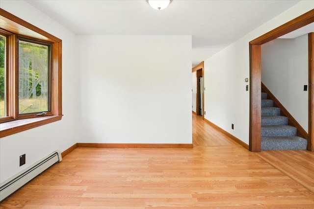 473 Davenport Hill Rd, Jay, ME 04239 - empty room with baseboard heating, light wood finished floors, stairs, and baseboards