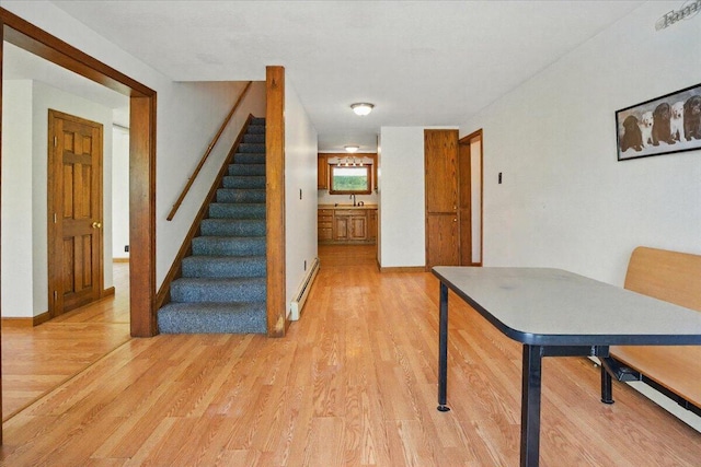 473 Davenport Hill Rd, Jay, ME 04239 - staircase with a baseboard radiator, wood finished floors, and baseboards