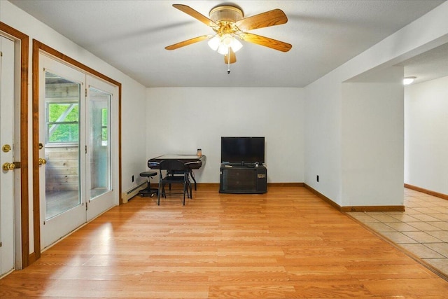 473 Davenport Hill Rd, Jay, ME 04239 - living area with light wood-type flooring, a ceiling fan, baseboard heating, and baseboards