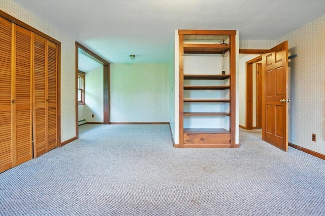 473 Davenport Hill Rd, Jay, ME 04239 - unfurnished bedroom with carpet floors, baseboards, a closet, wallpapered walls, and a baseboard heating unit