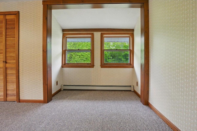 473 Davenport Hill Rd, Jay, ME 04239 - carpeted empty room featuring baseboard heating, wallpapered walls, and baseboards