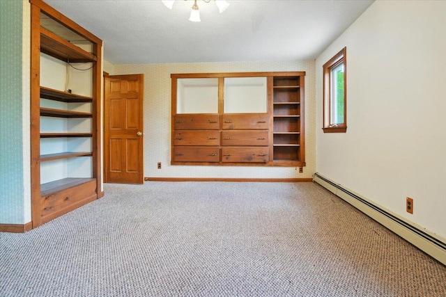 473 Davenport Hill Rd, Jay, ME 04239 - unfurnished bedroom with a baseboard heating unit, baseboards, a closet, and carpet flooring