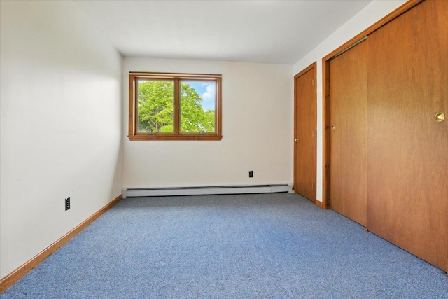 473 Davenport Hill Rd, Jay, ME 04239 - unfurnished bedroom featuring baseboard heating, carpet flooring, a closet, and baseboards