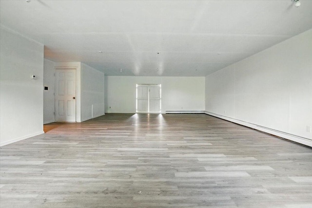 473 Davenport Hill Rd, Jay, ME 04239 - empty room with wood finished floors, baseboards, and a baseboard radiator