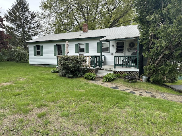 114 Summit Ave, Farmington, ME 04938 - view of front facade featuring a front yard, metal roof, and a chimney