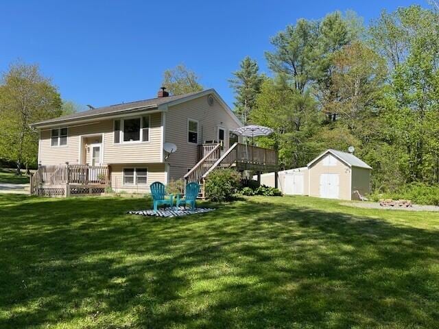 1007 Old Stage Rd, Woolwich, ME 04579 - back of house with a deck, stairway, a yard, and a chimney