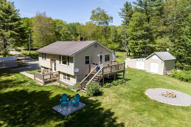 1007 Old Stage Rd, Woolwich, ME 04579 - rear view of house with a fire pit, a deck, a lawn, a chimney, and stairway