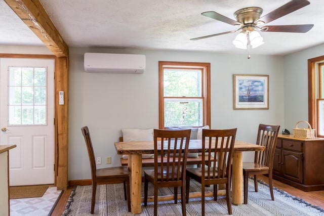 1007 Old Stage Rd, Woolwich, ME 04579 - dining space with a wall mounted AC, plenty of natural light, light wood-type flooring, and ceiling fan