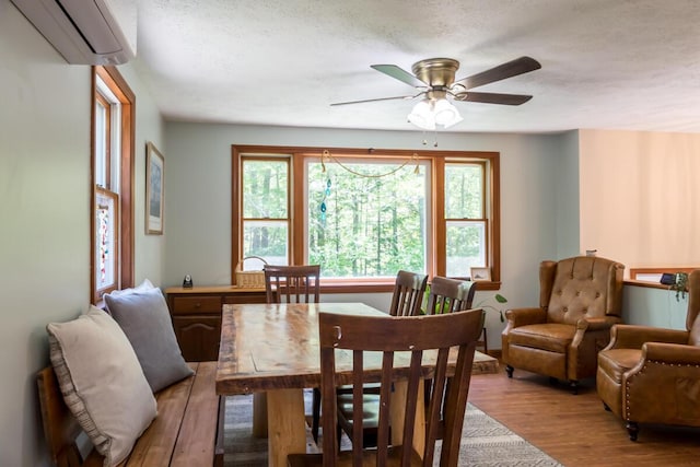 1007 Old Stage Rd, Woolwich, ME 04579 - dining area with an AC wall unit, light wood-style flooring, and ceiling fan