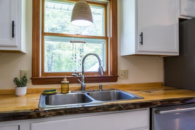 1007 Old Stage Rd, Woolwich, ME 04579 - kitchen with a sink, stainless steel dishwasher, white cabinets, and plenty of natural light