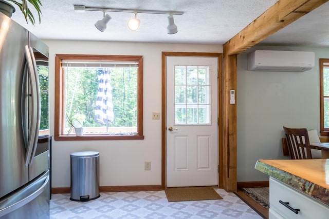 1007 Old Stage Rd, Woolwich, ME 04579 - doorway to outside featuring an AC wall unit, plenty of natural light, baseboards, and light floors