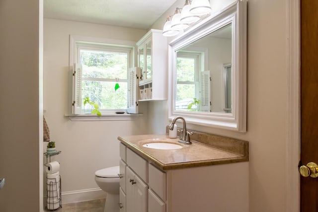 1007 Old Stage Rd, Woolwich, ME 04579 - bathroom with toilet, vanity, plenty of natural light, and baseboards