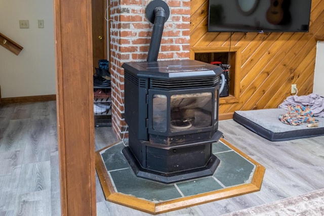 1007 Old Stage Rd, Woolwich, ME 04579 - detailed view of a wood stove, wood finished floors, and baseboards