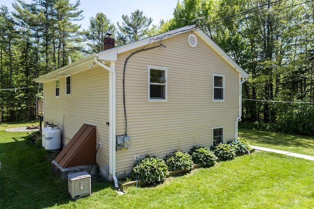 1007 Old Stage Rd, Woolwich, ME 04579 - view of property exterior with a chimney and a yard