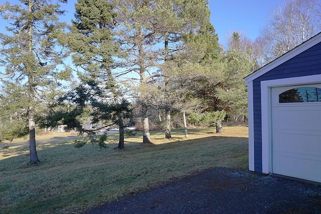 27 Misty Harbor Ln Unit 210, Cutler, ME 04626 - view of grassy yard with a garage