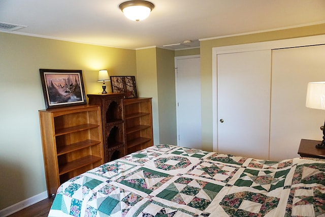 27 Misty Harbor Ln Unit 210, Cutler, ME 04626 - bedroom featuring a closet, ornamental molding, dark wood-style floors, and baseboards