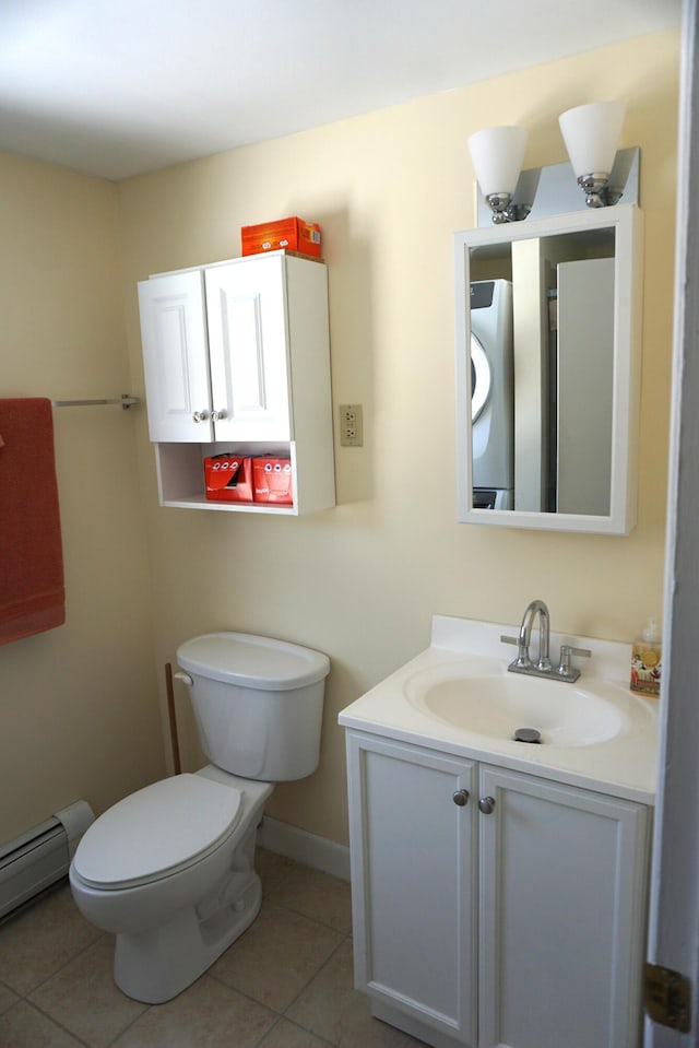 27 Misty Harbor Ln Unit 210, Cutler, ME 04626 - bathroom with a baseboard radiator, tile patterned floors, vanity, toilet, and baseboards