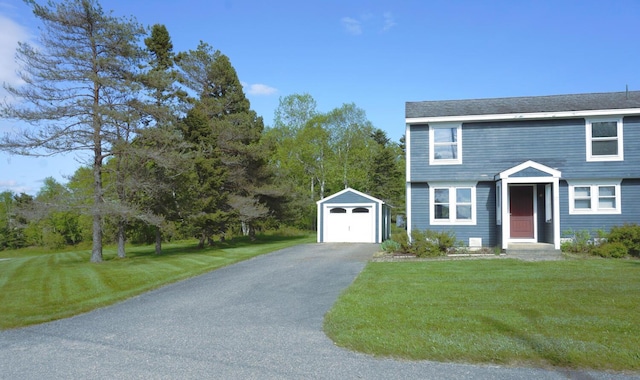 27 Misty Harbor Ln Unit 210, Cutler, ME 04626 - colonial home featuring an outbuilding, asphalt driveway, a front lawn, and a detached garage