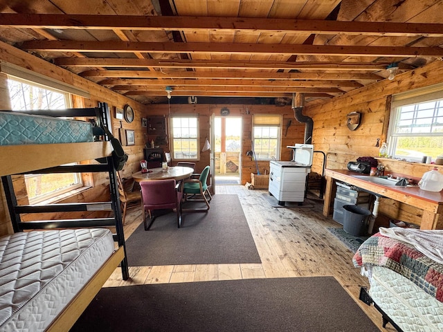 M2L3-M6L16 Campbell Rd, Whiting, ME 04691 - bedroom with light wood-style flooring, wooden walls, and a sink