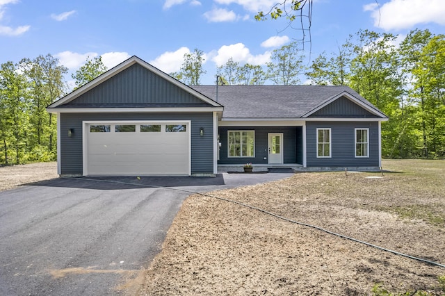 25 Sarah Vaughn Rd, Hollis, ME 04042 - ranch-style house featuring driveway, a garage, roof with shingles, and a porch