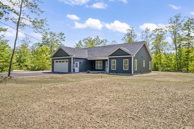 25 Sarah Vaughn Rd, Hollis, ME 04042 - single story home with a garage, asphalt driveway, a shingled roof, and a front yard