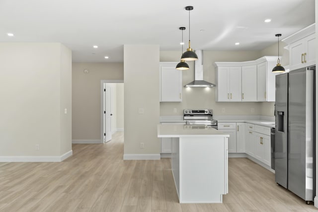 25 Sarah Vaughn Rd, Hollis, ME 04042 - kitchen featuring wall chimney range hood, appliances with stainless steel finishes, light countertops, a center island, and light wood-type flooring