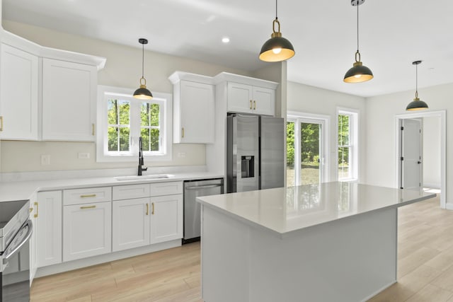 25 Sarah Vaughn Rd, Hollis, ME 04042 - kitchen with stainless steel appliances, plenty of natural light, white cabinetry, and a sink