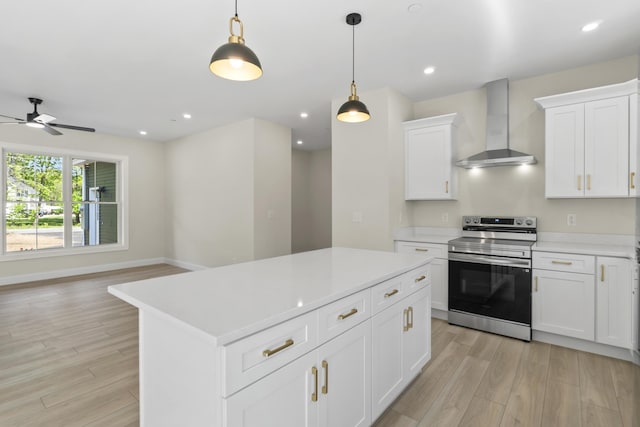 25 Sarah Vaughn Rd, Hollis, ME 04042 - kitchen featuring stainless steel electric range oven, wall chimney exhaust hood, light wood finished floors, ceiling fan, and light countertops
