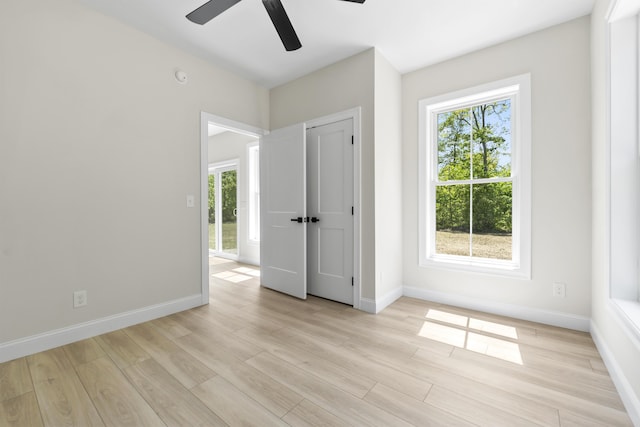 25 Sarah Vaughn Rd, Hollis, ME 04042 - unfurnished bedroom with multiple windows, light wood-type flooring, and baseboards