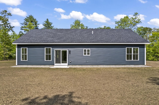 25 Sarah Vaughn Rd, Hollis, ME 04042 - back of property with a yard, a shingled roof, and a patio area