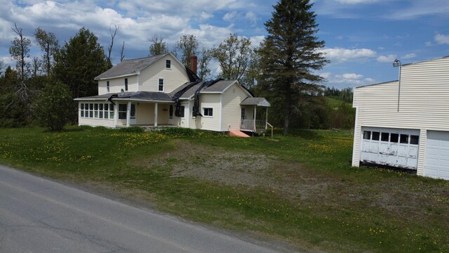 61 Brook Rd, Saint Agatha, ME 04772 - view of front facade with a sunroom and a front yard