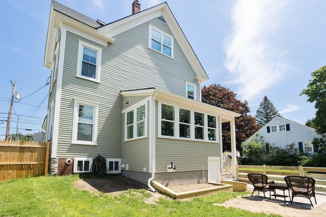 205 Beach St, Saco, ME 04072 - rear view of house featuring a chimney