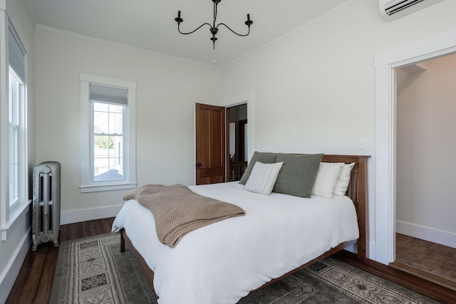 205 Beach St, Saco, ME 04072 - bedroom with radiator, a wall mounted AC, dark wood-style flooring, a chandelier, and ornamental molding