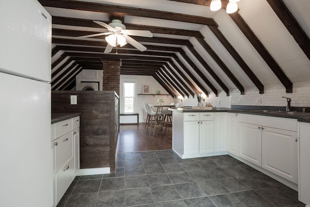 205 Beach St, Saco, ME 04072 - kitchen with a sink, dark countertops, ceiling fan, and white cabinetry