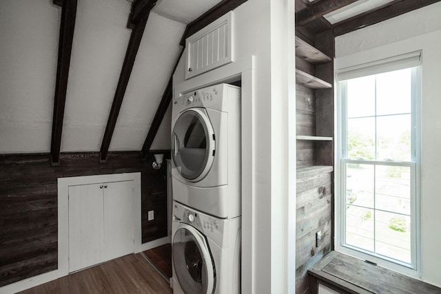 205 Beach St, Saco, ME 04072 - laundry area featuring stacked washer / dryer, dark wood-style flooring, and wooden walls