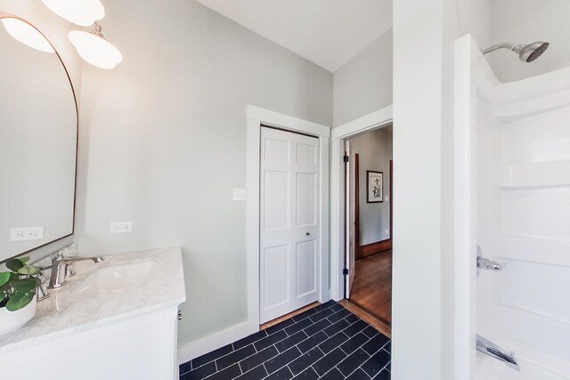 205 Beach St, Saco, ME 04072 - full bathroom featuring vanity, baseboards, tile patterned flooring, and a shower