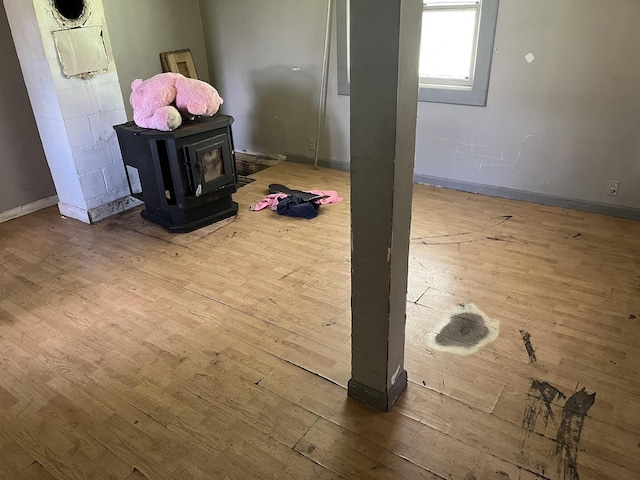 700 Warren Hill Rd, Palmyra, ME 04965 - below grade area with hardwood / wood-style flooring and a wood stove