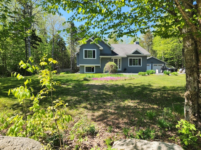 34 Sandy Acres Dr, Sullivan, ME 04664 - split level home with a front lawn, a chimney, and a garage
