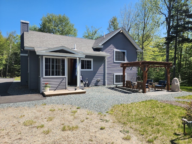34 Sandy Acres Dr, Sullivan, ME 04664 - rear view of property featuring a patio area, a chimney, and roof with shingles